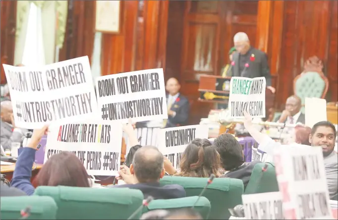  ?? (Keno George photo) ?? Placards and chants greeted President David Granger yesterday when he addressed Parliament.