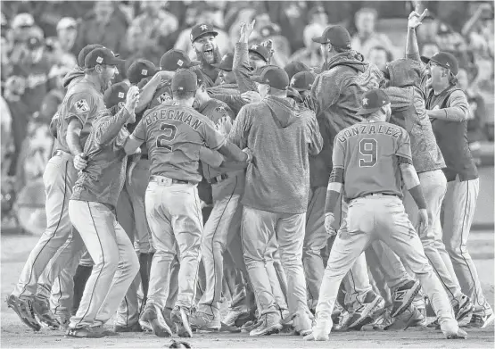  ?? Michael Ciaglo / Houston Chronicle ?? Last one in the dogpile is a rotten egg. No one among the Astros wanted to be left out of the celebratio­n following the franchise’s first World Series title.
