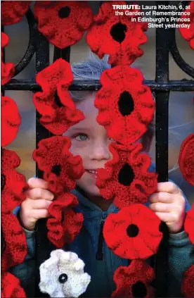  ??  ?? TRIBUTE: Laura Kitchin, 6, at the Garden of Remembranc­e in Edinburgh’s Princes Street yesterday