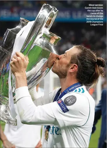  ??  ?? Silver service: Gareth Bale kisses the cup after he
came off the bench to change the course of the 2018 Champions
League Final