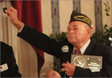  ?? CHARLES PRITCHARD — ONEIDA DAILY DISPATCH ?? William Yorton displays the pin he was awarded in the Boy Scouts reading “God and Country” at the Madison County Veteran of the Year Award on Saturday, Nov. 3, 2018.