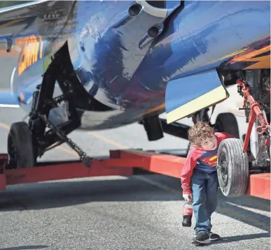  ??  ?? Ayden Barrett, 7, gets a close look at Millington’s Blue Angel while in transit back to its home at the Millington airport Saturday. The F-11 has greeted visitors to the Navy Base since 1975, and is returning after the completion of a paint and...
