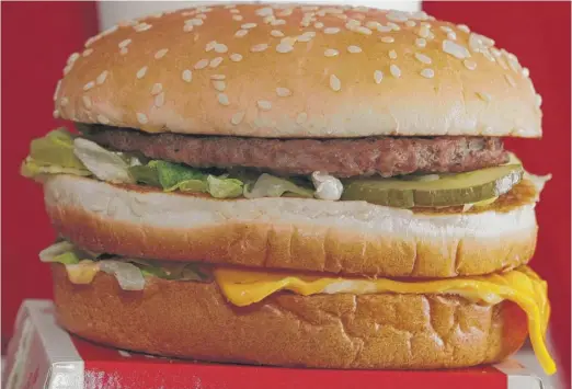  ?? KEITH SRAKOCIC/AP ?? McDonald’s double-decker Big Mac hamburger was launched by Pittsburgh franchisee Michael James “Jim” Delligatti with the company’s standard bun but failed to take off. Delligatti tried a bigger, sesame-seed bun, and the burger lifted sales by 12...