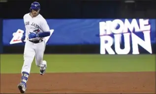  ?? NATHAN DENETTE, THE CANADIAN PRESS ?? Blue Jays’ Justin Smoak rounds the bases after hitting a two-run homer in the eighth to snap a 3-3 tie in a 5-3 win.