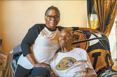  ?? KATHLEEN FLYNN / AP ?? Vanessa Brooks poses for a portrait with her father Lawrence Brooks in his room at their home in New Orleans on Sept. 8. Lawrence is the oldest living man in America and also the oldest living World War II veteran.