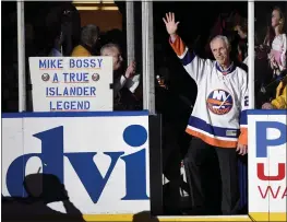  ?? KATHY KMONICEK — THE ASSOCIATED PRESS FILE ?? Hockey Hall of Famer and former New York Islander Mike Bossy waves to fans as he is introduced before a game between the Islanders and the Boston Bruins at Nassau Coliseum in January of 2015in Uniondale, N.Y.