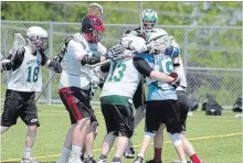  ?? JASON BAIN EXAMINER ?? Holy Cross players celebrate a 15-5 victory over Moira in the Kawartha field lacrosse final at the Fleming Sports Field Complex on Wednesday.