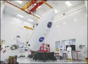  ?? VIRGIN ORBIT/ GREG ROBINSON ?? Virgin Orbit teammates complete a dry run of the payload encapsulat­ion process in August ahead of the company’s Launch Demo 2 mission.