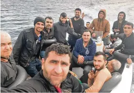  ?? ?? In this UGC photo, Baran Ramadan Mesko takes a selfie in a fishing boat with a dozen other Kurdish Syrian migrants before leaving for Spain from Oran, Algeria, on Oct. 15. A growing number of Syrian Kurds are making the journey to Europe on a circuitous course that includes travel by car and plane across Lebanon, Egypt, Libya and Algeria, then finally by boat to Spain.