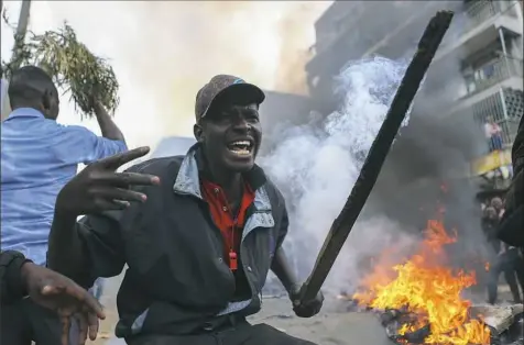  ?? AP ?? Residents of the Mathare area of Nairobi, Kenya, take to the streets Wednesday by blocking roads with burning tires to protest in support of Kenyan opposition leader and presidenti­al candidate Raila Odinga. Mr. Odinga alleges that hackers manipulate­d...