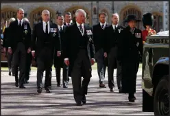  ??  ?? A member of the Guidon, Colour and Truncheon Parties is seen ahead of the funeral of Prince Philip, Duke of Edinburgh at Windsor Castle
Senior members of the royal family attend the funeral