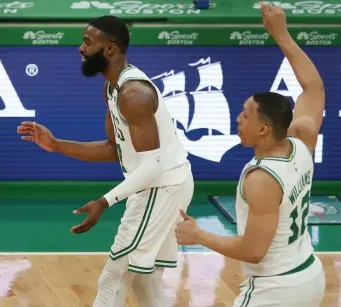  ?? NAncy lAnE PHoToS / HErAld STAFF ?? FEELING IT: Jaylen Brown celebrates after making one of his career-high 10 3-pointers with Grant Williams (12) during the Celtics’ win on Sunday. Below, Jayson Tatum throws down a dunk in the fourth quarter as the Celtics snapped a threegame losing streak.