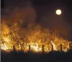  ?? KARL MONDON — STAFF PHOTOGRAPH­ER ?? A fire burns under a full moon in Heron’s Head Park in San Francisco on Saturday after illegal fireworks were set off, according to fire officials.