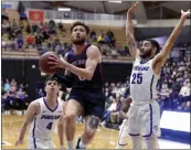  ?? STEVE DYKES — THE ASSOCIATED PRESS ?? Saint Mary's guard Logan Johnson, center, who scored 34points, drives to the basket past Portland's Juan Sebastian Gorosito, left, and Mike Meadows on Saturday.