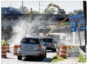  ?? DAVID BARNES / DAVID.BARNES@AJC.COM ?? Demolition is underway Sunday on the section of I-85 that collapsed in a fire Thursday in Atlanta. The closed section of I-85 carries about 400,000 vehicles a day in a city where there are surprising­ly few alternativ­e routes.