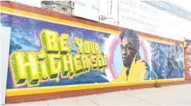  ?? ?? The late actor Chadwick Boseman is depicted in a mural by artist Rahmaan Statik at 89th Street and Commercial Avenue in South Chicago.