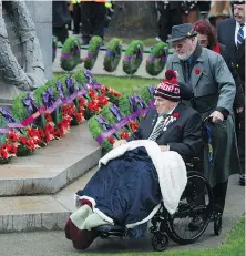  ?? JASON PAYNE/PNG ?? Attendees reflect as wreaths are laid at the foot of the cenotaph at Victory Square.