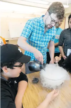  ?? MICHAEL BELL ?? Vincent Ziffle pours liquid nitrogen into a bowl during a session on the chemistry of ice cream at the National First Nation and Inuit Youth Science Camp at First Nations University of Canada on Tuesday.