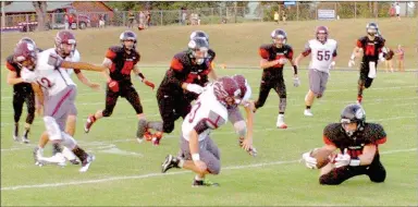  ?? MARK HUMPHREY ENTERPRISE-LEADER ?? Keys, Okla., junior R.J. Winslow recovers an onside kick with the Cougars leading 18-7 in the first quarter. Keys converted the possession into another score on the way to handing the Wolves a 46-13 nonconfere­nce loss Friday.