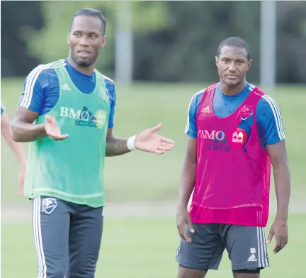  ?? J O H N K E N N E Y/ MO N T R E A L G A Z E T T E ?? New Impact player Didier Drogba, left, with teammate Patrice Bernier during practice. The former Chelsea star is working his way into shape and is not expected to dress for the game against D. C. United on Saturday night.