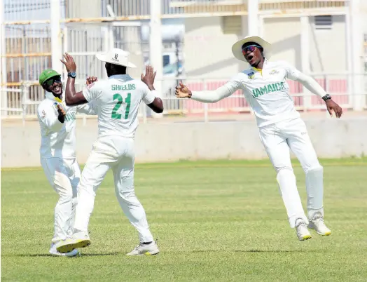  ?? PHOTO BY LENNOX ALDRED ?? Jamaica Scorpions captain Jermaine Blackwood (left) celebrates with Ojay Shields (centre) and Carlos Brown after the team picked up the wicket of Jonathan Carter of Combined Campuses and Colleges during their West Indies Championsh­ip encounter at Sabina Park yesterday.