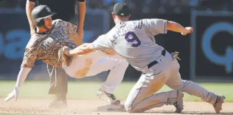  ?? Alex Gallardo, The Associated Press ?? Rockies second baseman DJ LeMahieu tags the Padres’ Cory Spangenber­g at second base for a sixth-inning out Sunday afternoon at Petco Park in San Diego. Spangenber­g was trying to stretch his single into a double.