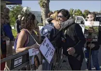  ?? AP ?? Eli Shtivi, whose son Idan has been held in Gaza since he was kidnapped Oct. 7, is embraced Saturday by a woman outside Israeli Prime Minister Benjamin Netanyahu’s residence in Caesarea, Israel.