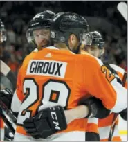  ?? TOM MIHALEK — THE ASSOCIATED PRESS ?? The Flyers’ Jake Voracek gives old friend Claude Giroux a well-deserved hug after one of two second-period goals for Giroux Saturday at Wells Fargo Center.
