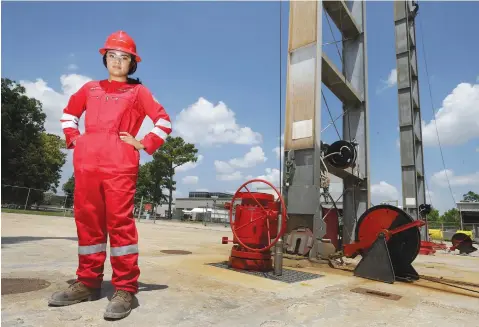  ?? Melissa Phillip/Houston Chronicle via AP ?? ■ Maysarah Mikail, a Halliburto­n senior technical profession­al, poses for a photo in her gender-specific coveralls Aug. 17 at Halliburto­n in Houston.