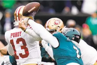  ?? SETH WENIG AP ?? Eagles linebacker Haason Reddick causes a fumble by hitting 49ers quarterbac­k Brock Purdy’s arm during his windup in the first quarter of the NFC Championsh­ip on Sunday in Philadelph­ia.