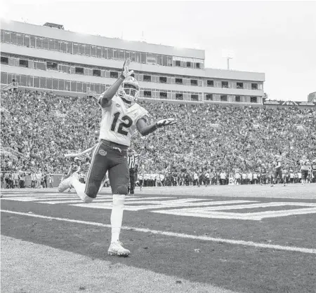  ?? MARK WALLHEISER/AP PHOTOS ?? Florida wide receiver Van Jefferson does the Gator chomp after hauling in a 38-yard touchdown catch during the Gators’ victory over rival FSU.