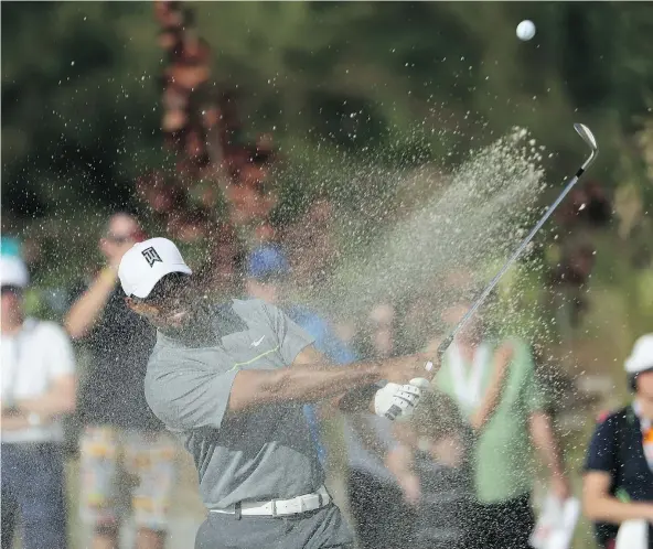  ?? — GETTY IMAGES ?? Tiger Woods hits an approach shot on the 11th hole during the third round of the Hero World Challenge in Nassau, Bahamas, on Saturday. Woods was playing his first tournament in 15 months as he recovers from an assortment of injuries.