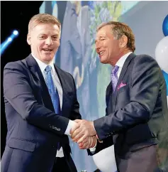  ??  ?? English (left) shakes hands with Peters during an election night event in Auckland. — Reuters photo