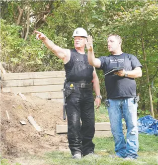  ?? THE HOLMES GROUP ?? Summer storms can damage roofs, trees and a homes's exterior. To play it safe, have a pro look for any potential issues, says Mike Holmes, left, on location of Holmes Makes it Right with Jon Mcclennan.