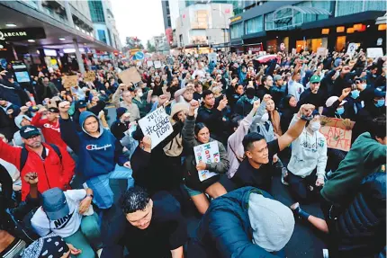  ?? Photo: AP ?? Demonstrat­ors hold placards during a march in central Auckland, New Zealand on June 1, 2020, to protest the death of United States’ George Floyd, a black man who died in Police custody in Minneapoli­s on May 25.