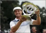  ?? MEL EVANS — THE ASSOCIATED PRESS ?? Bryson DeChambeau holds up the trophy after winning the Northern Trust golf tournament, Sunday in Paramus, N.J.