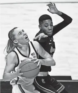  ?? JESSICA HILL/AP ?? UConn’s Paige Bueckers, left, looks to shoot against St. John's Kadaja Bailey in a Big East quarterfin­al game Saturday.