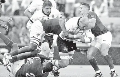  ??  ?? Italy’s Sergio Parisse (2nd R) is tackled during the Japan 2019 Rugby World Cup Pool B match between Italy and Namibia. - AFP photo