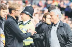  ??  ?? Liverpool manager Jurgen Klopp and his Manchester United counterpar­t Jose Mourinho before the match. — Reuters photo