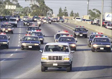 ?? Allen J. Schaben Los Angeles Times ?? 25 YEARS AGO to the day, CHP officers pursue fugitive O.J. Simpson, hiding in the rear of the Ford Bronco driven by Al Cowlings.