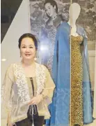  ??  ?? Author Frannie Jacinto posing in front of Elvira Manahan’s gown that she wore during the 1972 “Homage to Valera” show by Conchita Sunico