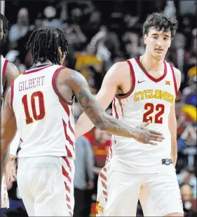  ?? Charlie Neibergall The Associated Press ?? Iowa State forward Milan Momcilovic (22) celebrates with guard Keshon Gilbert after upsetting No. 2 Houston on Tuesday. Iowa State won 57-53.