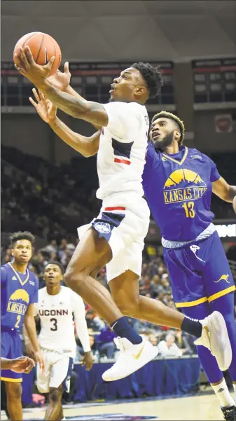  ?? Stephen Dunn / Associated Press ?? UConn’s Tarin Smith (2) scores against UMKC’s Jamel Allen (13) in the first half Sunday.