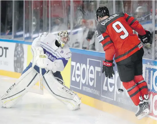  ?? — THE ASSOCIATED PRESS ?? France goalie Florian Hardy, left, clears the puck past Canada’s Matt Duchene during preliminar­y round action on Thursday at the world hockey championsh­ips in Paris. Canada edged France 3-2 for its fourth straight victory.