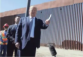  ?? EVAN VUCCI/AP ?? President Donald Trump talks with reporters as he tours a section of the southern border wall in Otay Mesa, Calif., on Sept. 18.