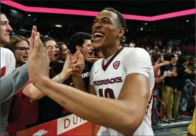  ?? Associated Press ?? Celebrator­y mood: Arkansas forward Daniel Gafford celebrates with fans after the Razorbacks defeated Auburn 91-82 in February. Gafford, from El Dorado, was named to the SEC All-Freshman Team this week.