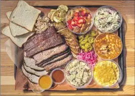  ?? Jay L. Clendenin Los Angeles Times ?? A SAMPLING OF meats and sides from Moo’s Craft Barbecue, which has carved out an identity as a Texas-style barbecue destinatio­n in Los Angeles.