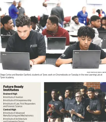  ?? STAFF PHOTOS BY ERIN O. SMITH ?? Diego Cortez and Brandon Sanford, students at Tyner, work on Chromebook­s on Tuesday in the new Learning Lab at Tyner Academy. Tyner students take part in a ribbon-cutting for their new Learning Lab on Tuesday.
