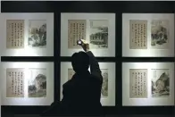  ?? PROVIDED TO CHINA DAILY ?? A visitor at the ongoing show, Intimate Encounter, from the M K Lau Collection, featuring works of 20th century ink-and-brush paintings, at the Guardian Art Center in Beijing.