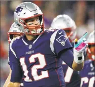  ?? Michael Dwyer / Associated Press ?? Patriots quarterbac­k Tom Brady signals as he runs to the sideline after his team scored a touchdown in the second half against the Chiefs on Monday.